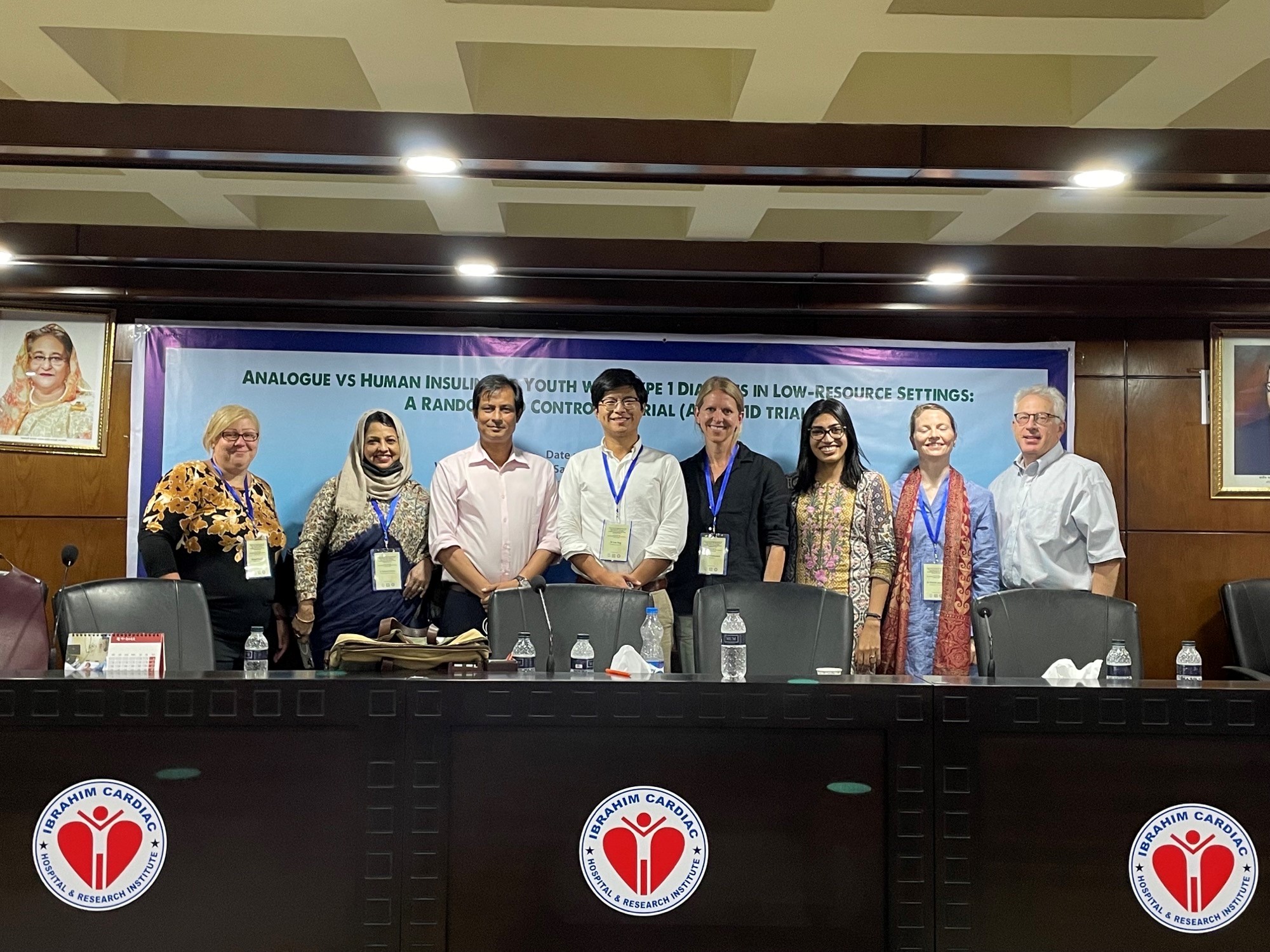 Members of the HumAn-1 study team standing behind a table at a conference.