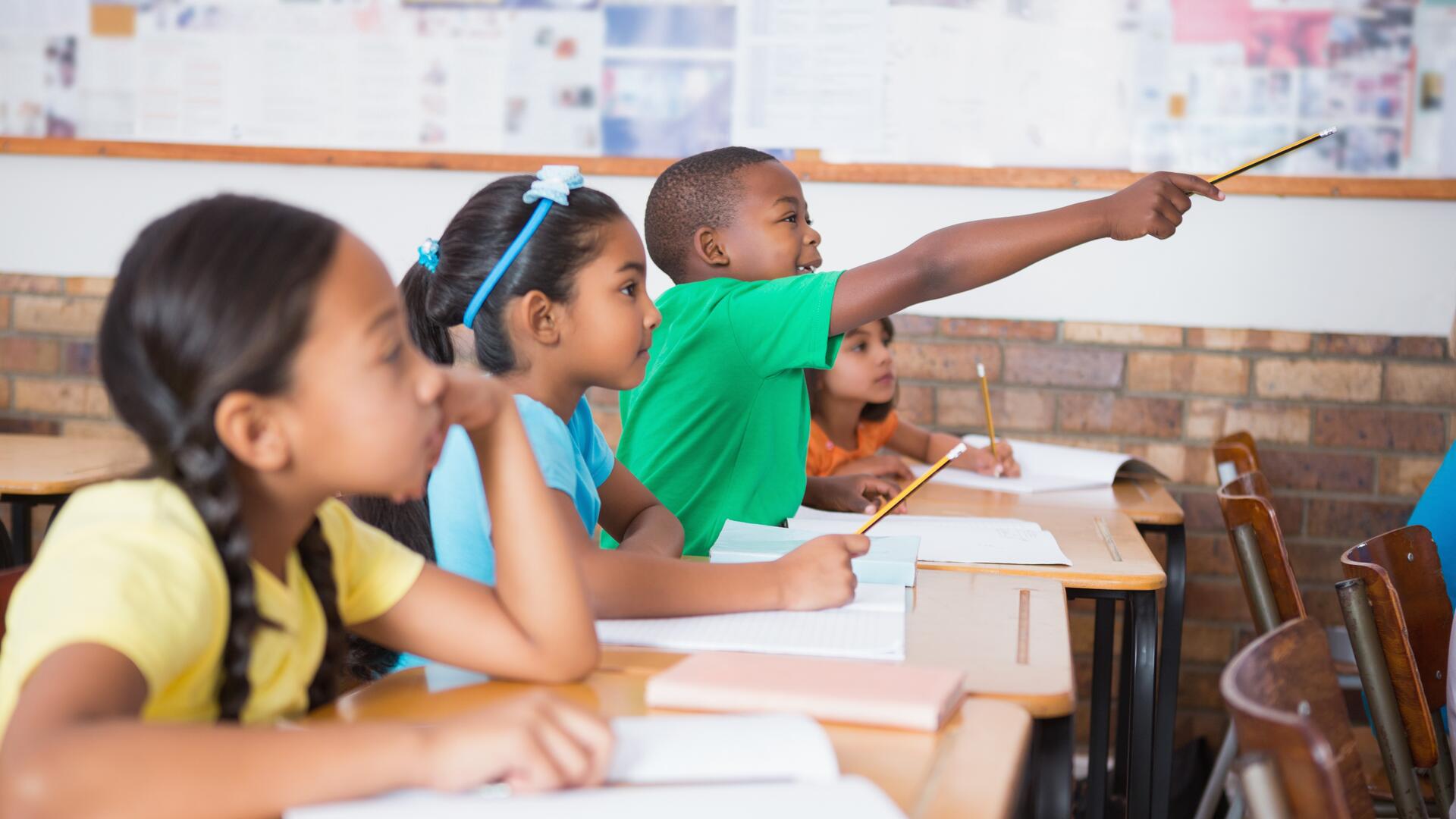 Children in classroom excited to learn 